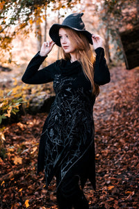 Long asymmetrical cowl neck dress with a bird and tree branch print.