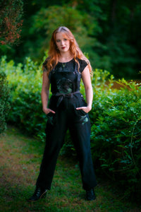 Woman posing wearing Forest Burial Overalls.