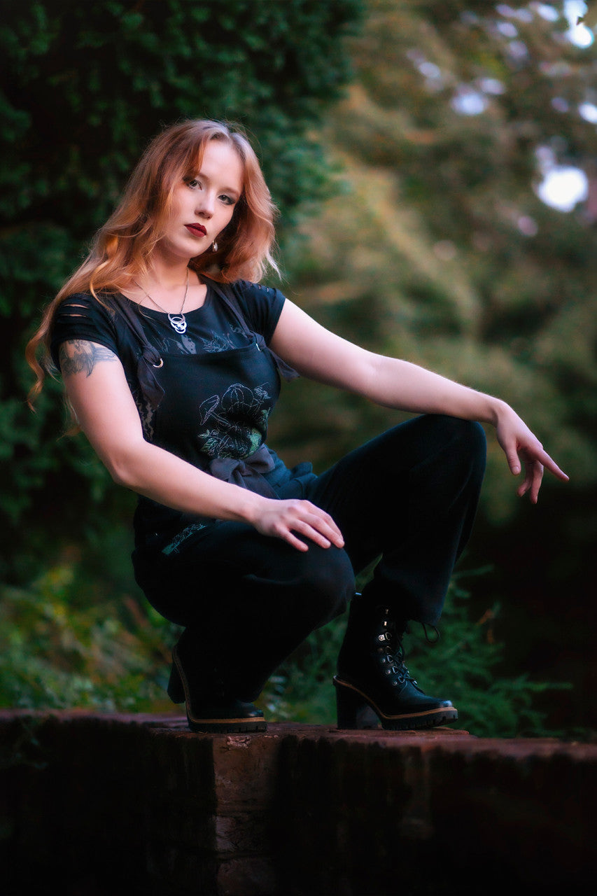 Woman posing wearing Forest Burial Overalls.