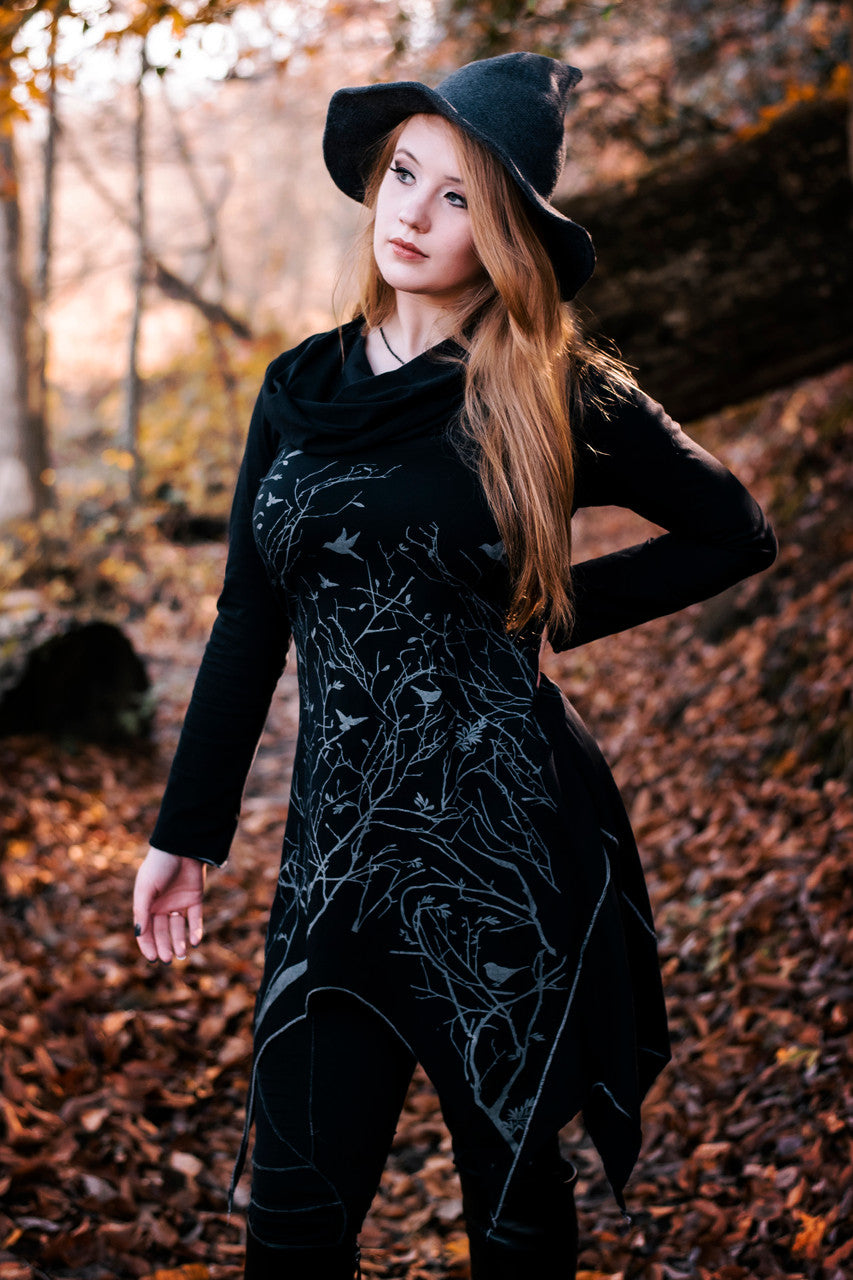 Long asymmetrical cowl neck dress with a bird and tree branch print.