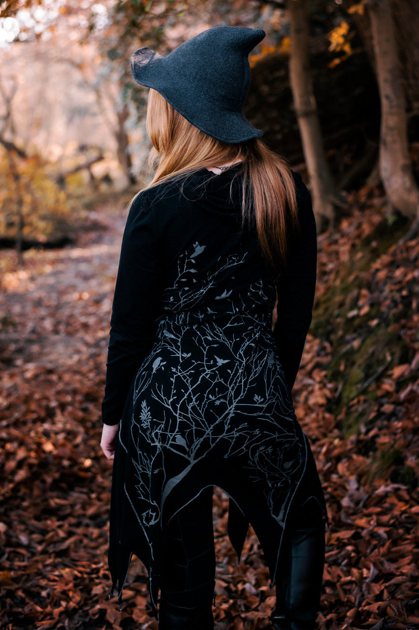 Long asymmetrical cowl neck dress with a bird and tree branch print.