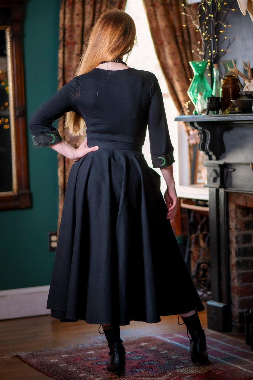 Forager Skirt, back view of a-line skirt model has hand resting on hip.