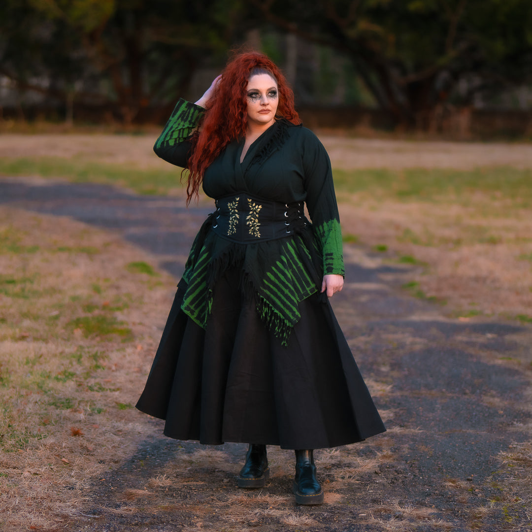 Plus-size model wearing a layered Dark Cottage cardigan, skirt and corset belt